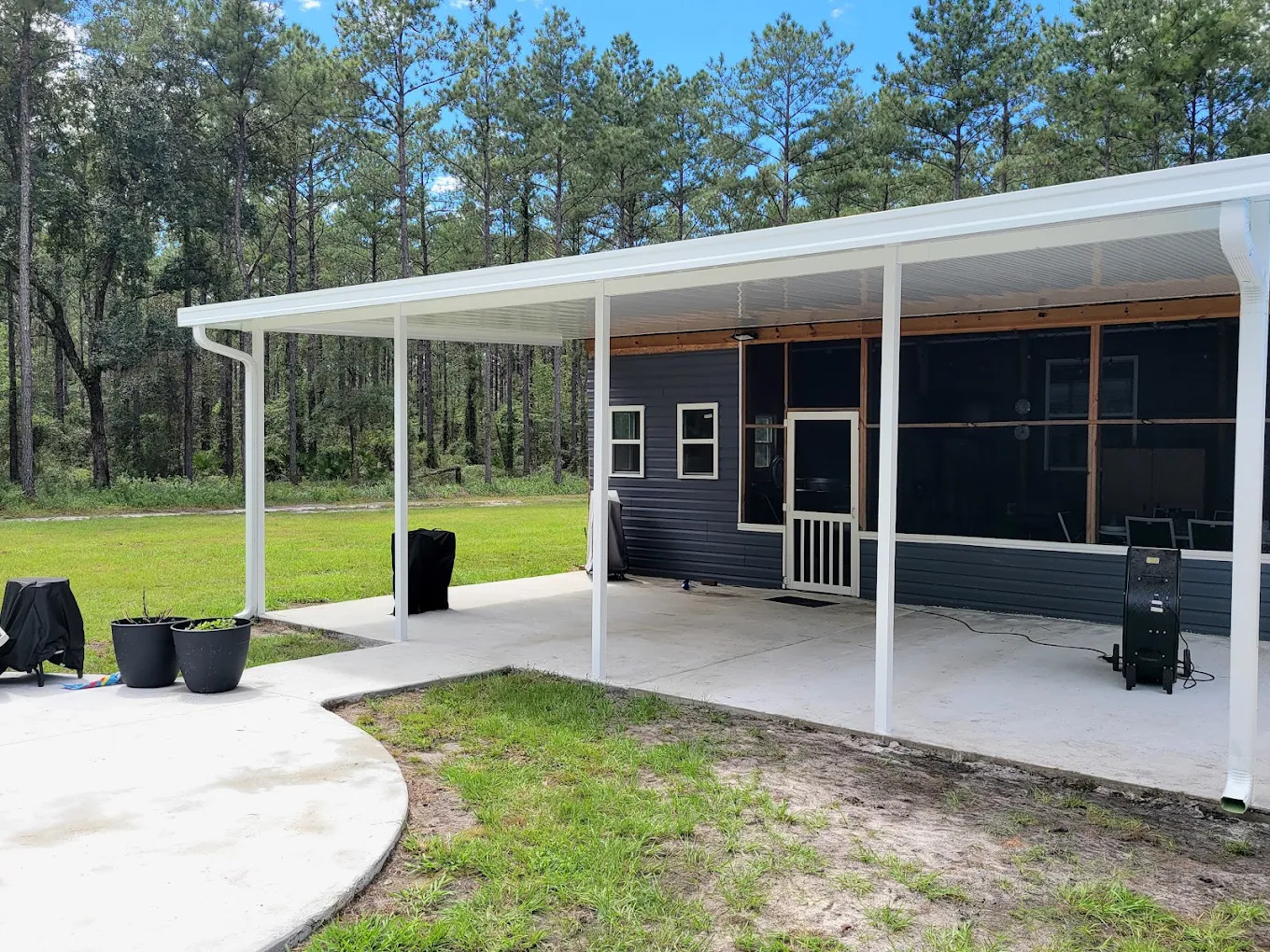 White aluminum patio cover beside a screened porch